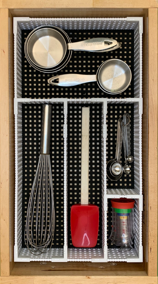 Baking utensiles organized in drawer by gingersnaps